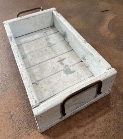 A small white wood tray at an Angle